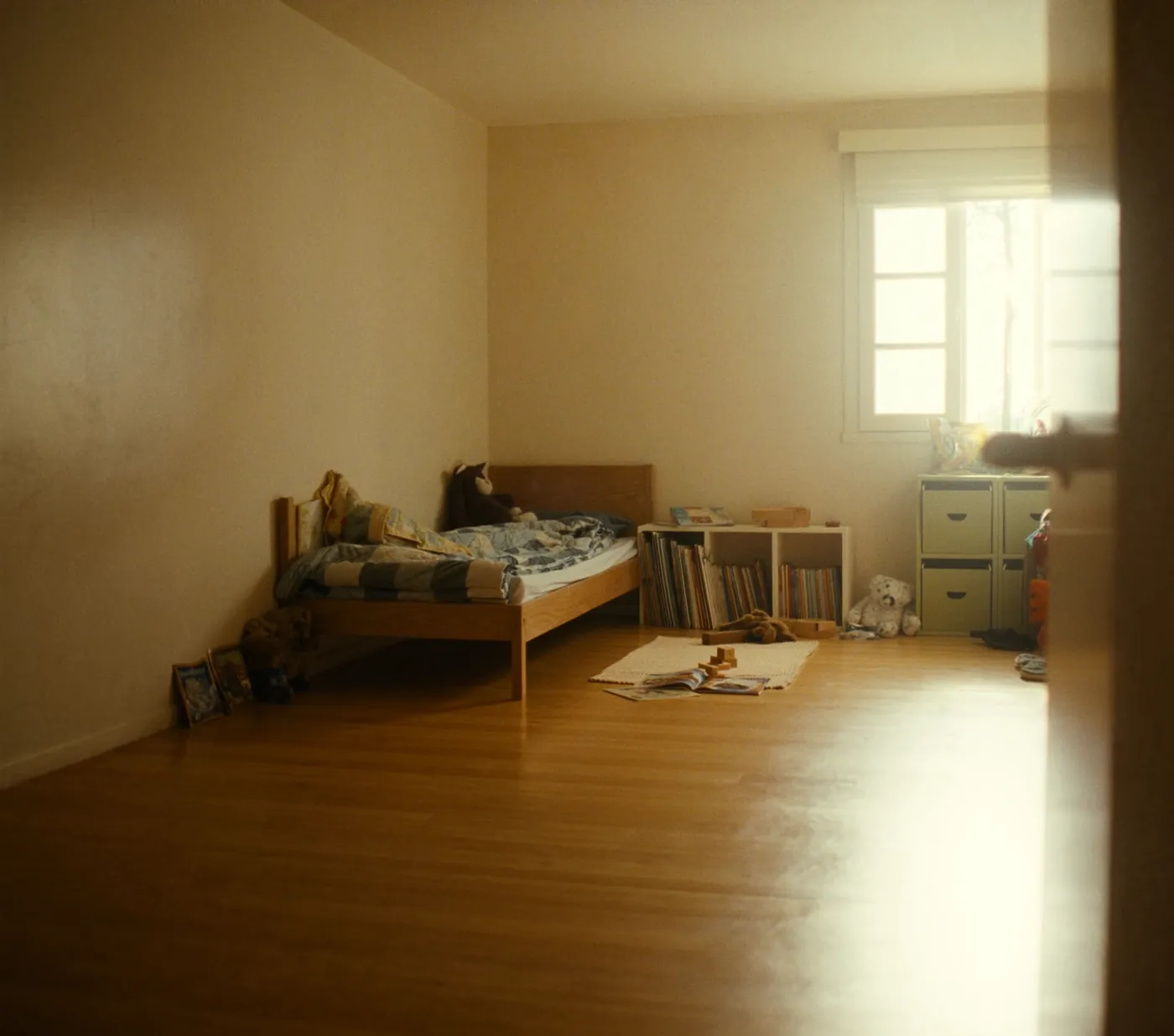A child's room with a small bed and toys